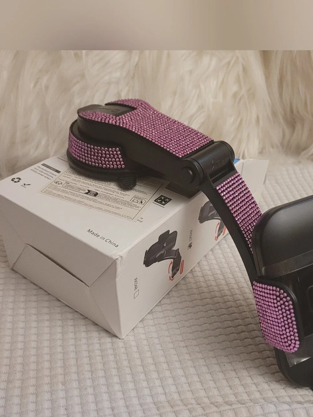 Pink universal car phone holder designed for attachment to a dashboard